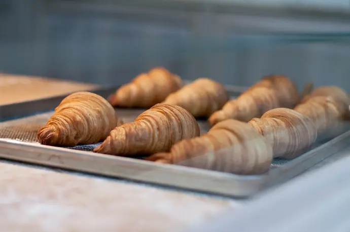 seven croissant on gray metal tray